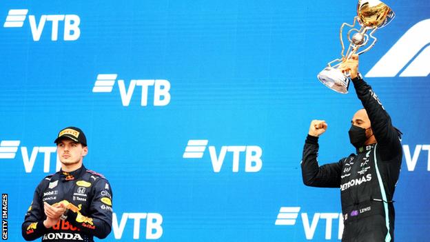 Lewis Hamilton celebrates winning the Russian Grand Prix next to second-placed Max Verstappen