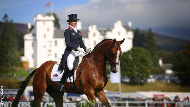 Equestrian rider on horse with Blair Castle in the background