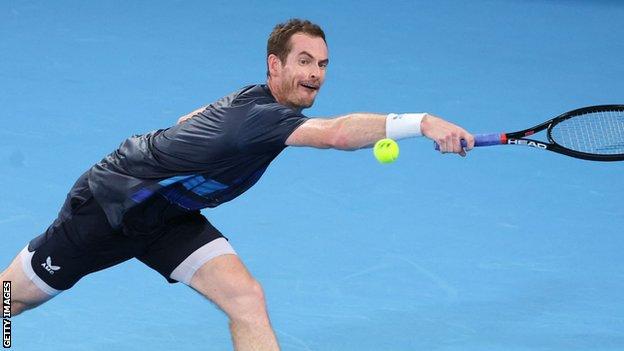 Andy Murray returns a ball against Aslan Karatsev in Sydney