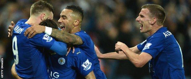 Jamie Vardy is surrounded by Leicester team-mates Danny Simpson and Marc Albrighton in celebration