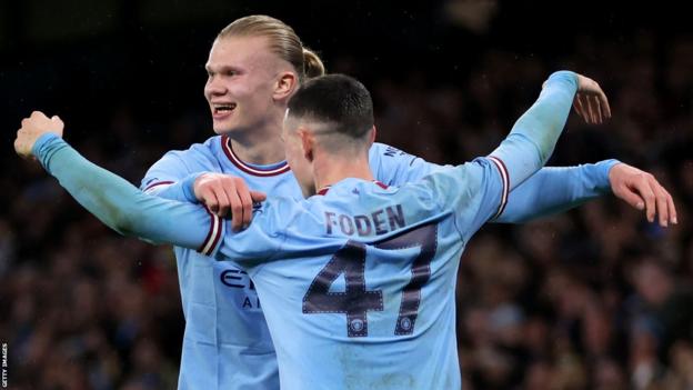 Manchester City's Erling Haaland celebrates scoring against Burnley in the FA Cup quarter-final with team-mate Phil Foden
