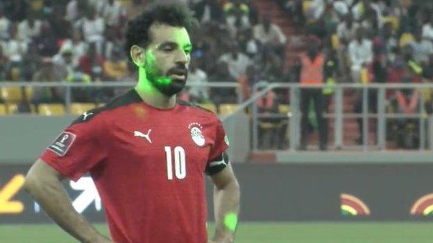 Salah was one of several players targeted by laser pens shone form the crowd as he prepared to take his penalty