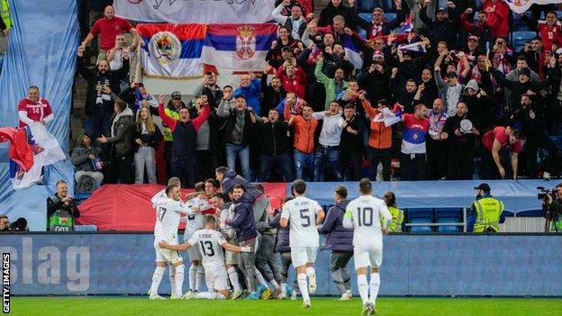 Serbia's forward Aleksandar Mitrovic (C) celebrates after scoring in the Nations League against Norway