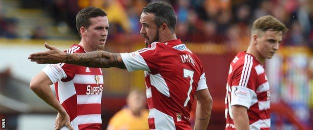 Hamilton player Dougie Imrie (centre) talks to team mates