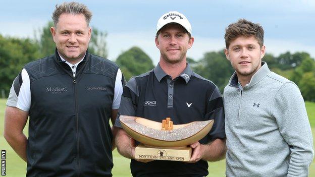 Last year's winner Robin Sciot-Siegrist (centre) received the NI Open trophy from Modest Golf directors Niall Horan (right) and Mark McDonnell