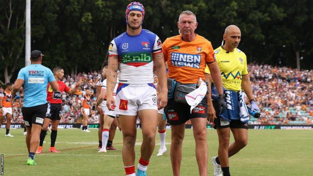 Newcastle Knights captain Kalyn Ponga being helped off the field