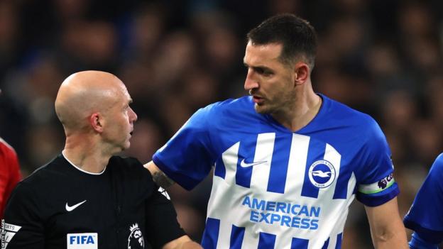 Brighton defender Lewis Dunk and referee Anthony Taylor