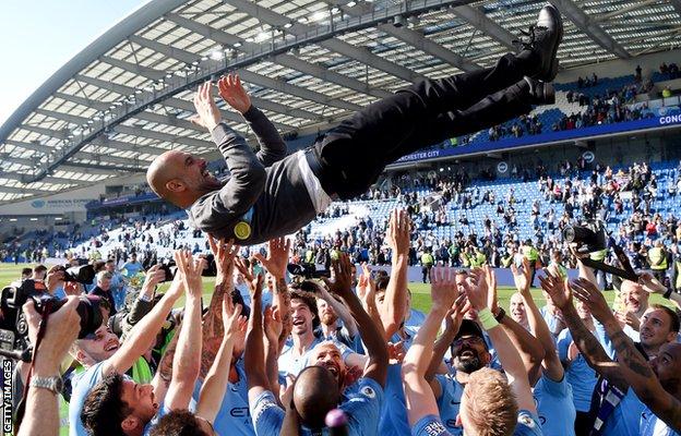 Pep Guardiola is thrown into the air by his Manchester City players as they celebrate their 2019 Premier League title