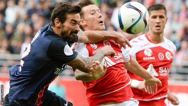 Franck Signorino of Reims challenges Paris Saint-Germain's Argentinian forward Ezequiel Lavezzi