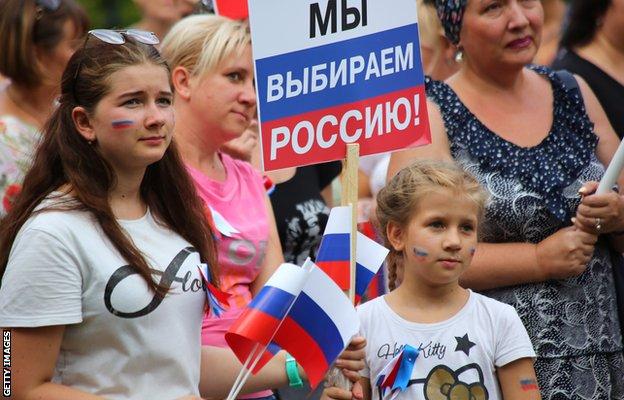 People in Donetsk attend an event marking Russia's National Flag Day in August 2019
