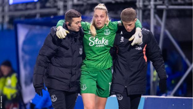 Emily Ramsey is helped off the pitch after being injured