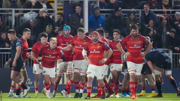 Munster's Craig Casey celebrtaes with the rest of his squad as he scores Munster's first try of the match during a BKT United Rugby Championship match between Edinburgh Rugby and Munster at the DAM Health Stadium