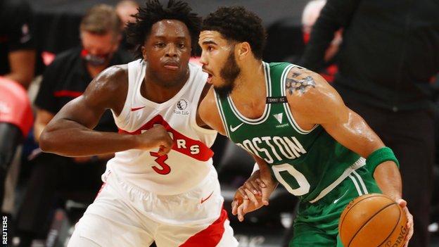 Jayson Tatum shields the ball