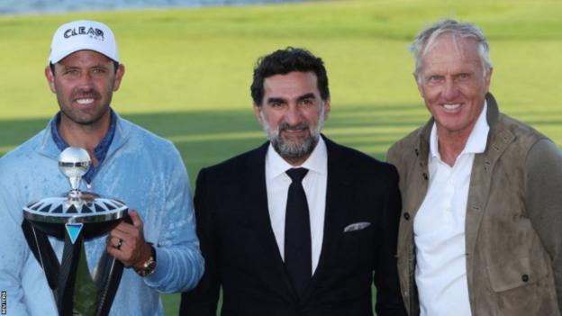 Charl Schwartzel with Yasir Al-Rumayyan and Greg Norman aft  winning the inaugural LIV Golf lawsuit   successful  June 2022