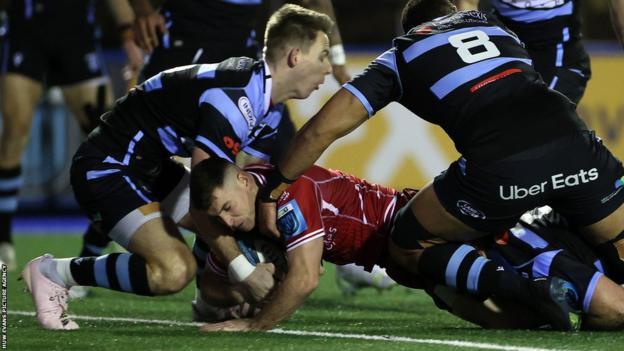 Dane Blacker of Scarlets gets over the line to score a try