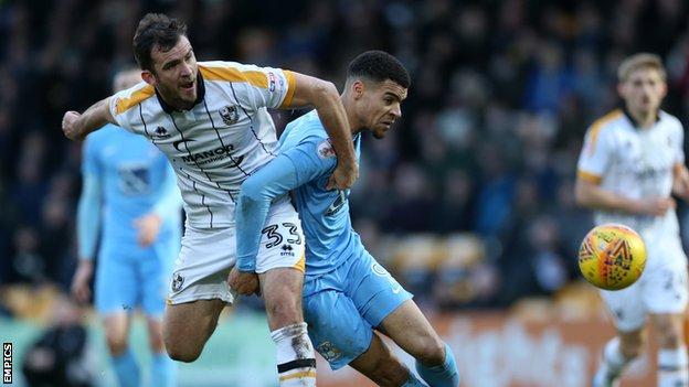 Port Vale defender Gavin Gunning challenges for the ball with Coventry City's Max Biamou