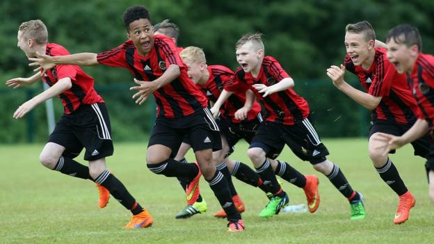 Hillsborough players celebrate after winning Under-13 Shield final in a penalty shoot-out against Carrick Rangers