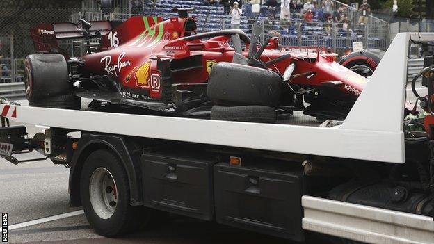 Charles Leclerc's crashed car is taken away on the back of a truck