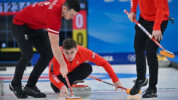 GB curler Grant Hardie plays a shot in match against the USA