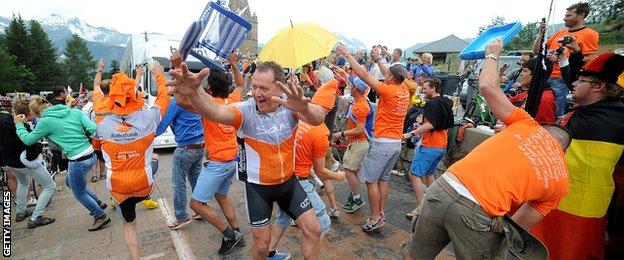 Fans at '"Dutch Corner" party and impede the traffic on the Alpe d'Huez stage of the 2013 Tour