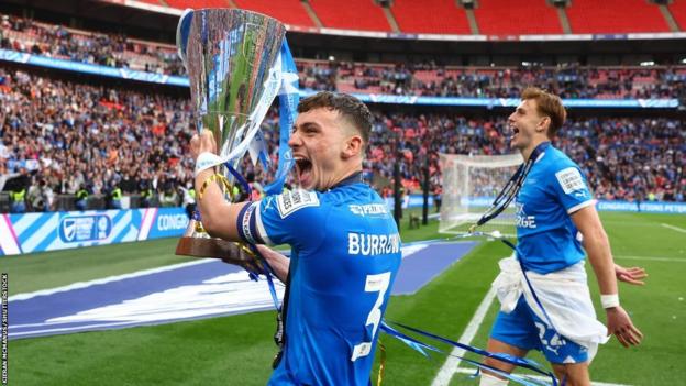 Harrison Burrows lifts the EFL Trophy at Wembley