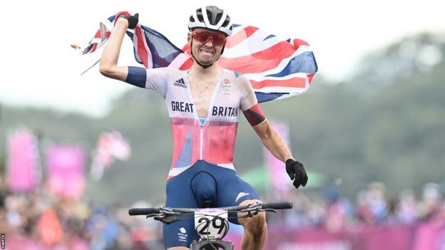 Tom Pidcock celebrating winning an Olympic gold medal in 2021