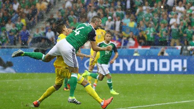Gareth McAuley heads Northern Ireland in front against Ukraine