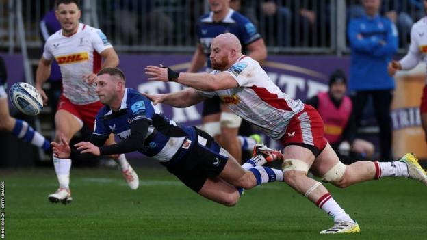 Bath fly-half Finn Russell gets a pass way under pressure from Quins flanker James Chisholm