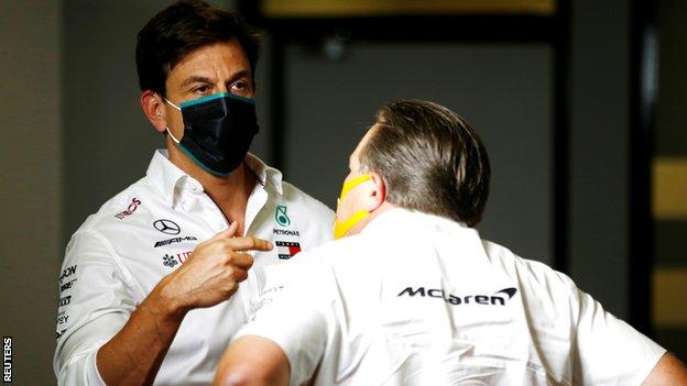 Toto Wolff chats with McLaren chief executive Zak Brown