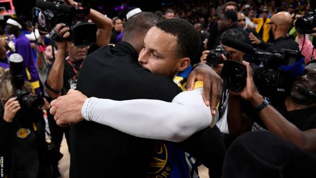 LeBron James embraces Stephen Curry