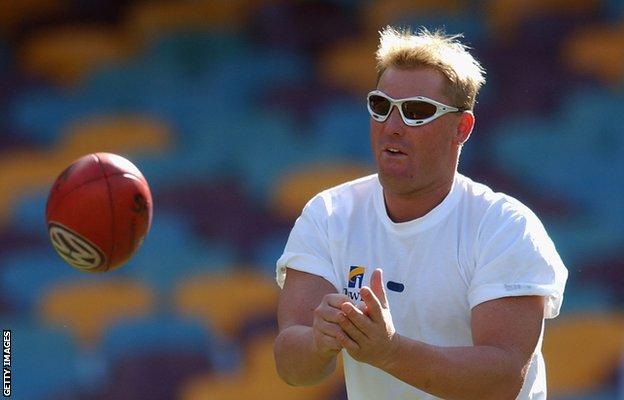 Shane Warne of the Australian cricket team in action during a joint training session with the Brisbane Lions AFL club