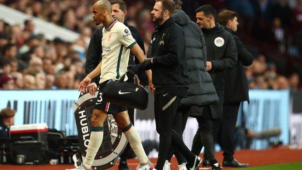 Fabinho limps off the pitch against Aston Villa