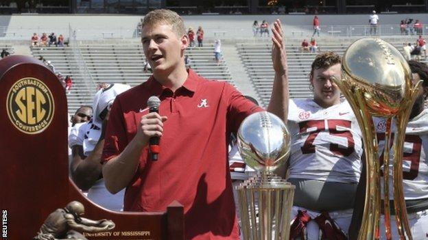 Mac Jones with the trophies he helped Alabama win in the 2020 season