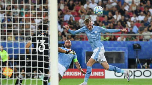 Cole Palmer heads the ball towards goal