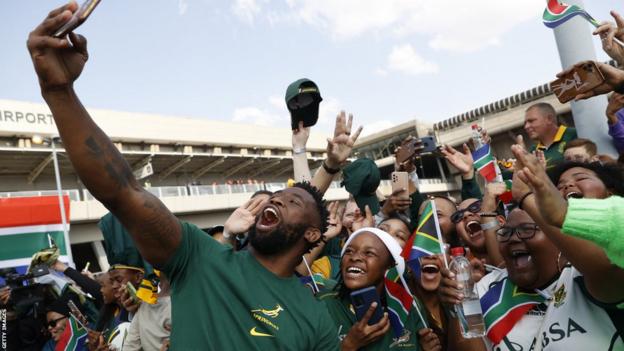Siya Kolisi takes a selfie with fans during South Africa's departure ceremony ahead of the Rugby World Cup
