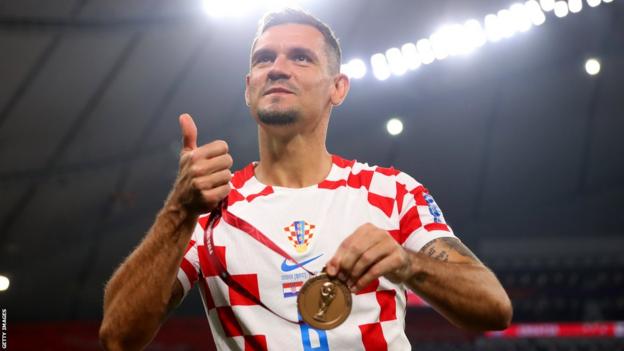 Dejan Lovren poses with his third place medal at the 2022 World Cup