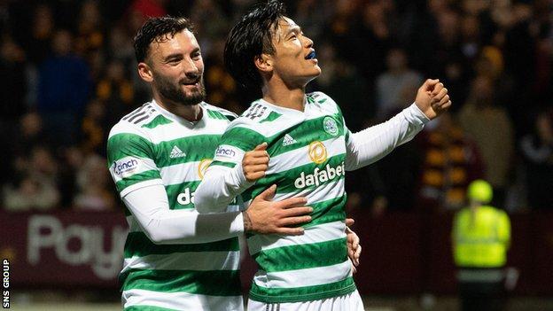 Celtic's Reo Hatate celebrates with Sead Haksabanovic after making it 3-0 during a Premier Sports Cup match between Motherwell and Celtic at Fir Park