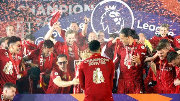 Liverpool's players celebrate as they lift the Premier League trophy