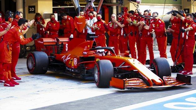 Ferrari team-mates applaud Sebastian Vettel ahead of the Abu Dhabi Grand Prix as he leaves the pit for his final race for the Scuderia