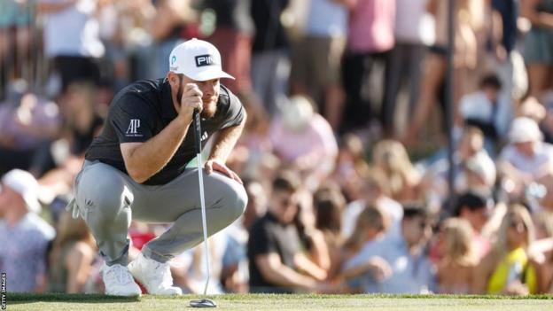 Tyrell Hatton weighs up a putt at the Phoenix Open