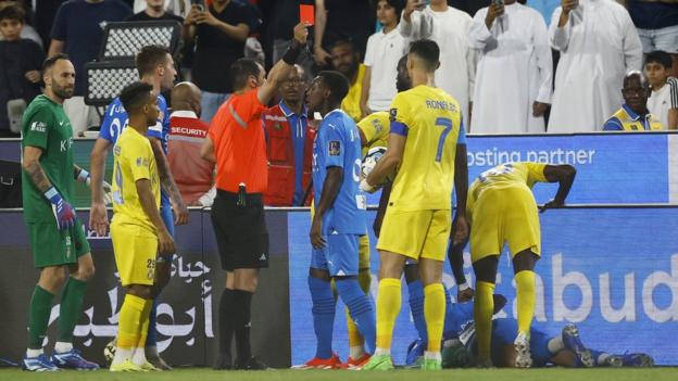 Cristiano Ronaldo being shown a red card by the referee following his clash with Al Bulayhi