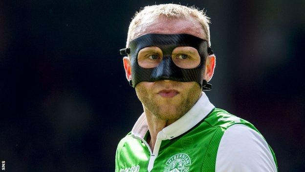 Dylan McGeouch, wearing a protective mask, in action for Hibs