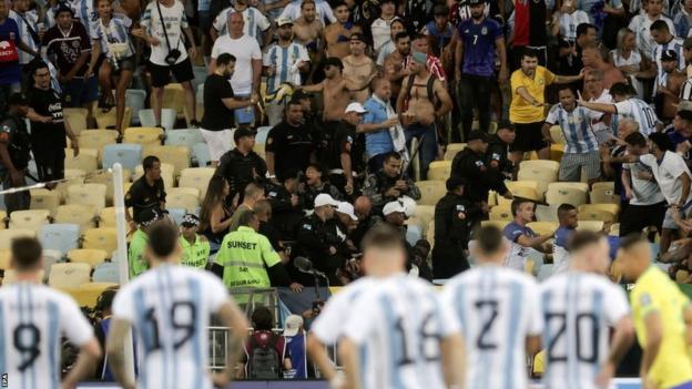 Argentina players looking on as trouble breaks out in the stands