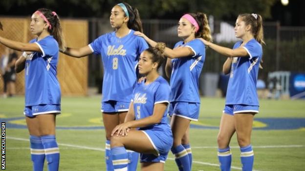 Kaiya McCullough kneels during the national anthem while playing for UCLA