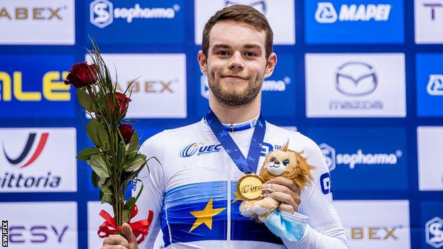 Britain's Matt Walls holds up his gold medal for winning the European omnium title