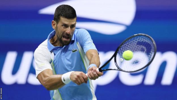 Novak Djokovic hits a return at the US Open