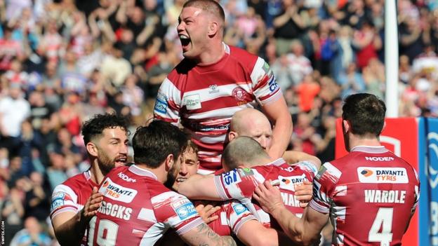 Morgan Smithies roars with delight arsenic Wigan observe Harry Smith's aboriginal effort against St Helens