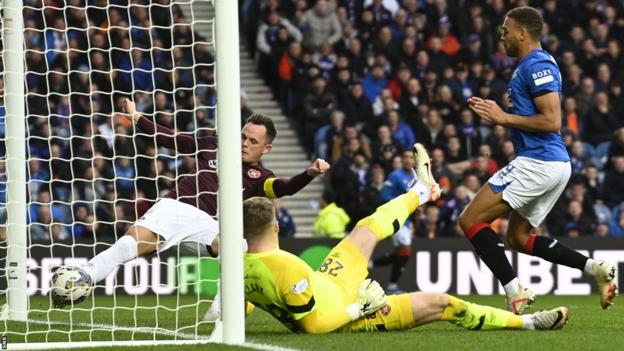 Hearts' Lawrence Shankland makes a goal-line clearance to deny Rangers