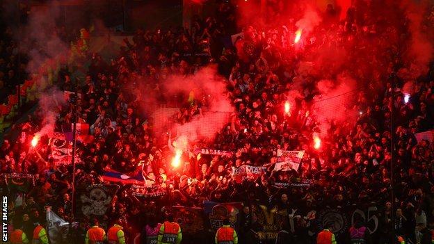 PSG fans holding flares at Old Trafford