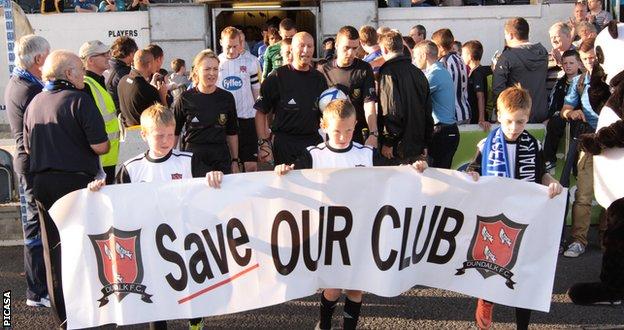 Fans with a 'Save Our Club' banner
